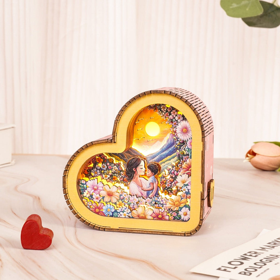 A heart-shaped 3D wooden puzzle night light featuring a mother and child design surrounded by flowers.