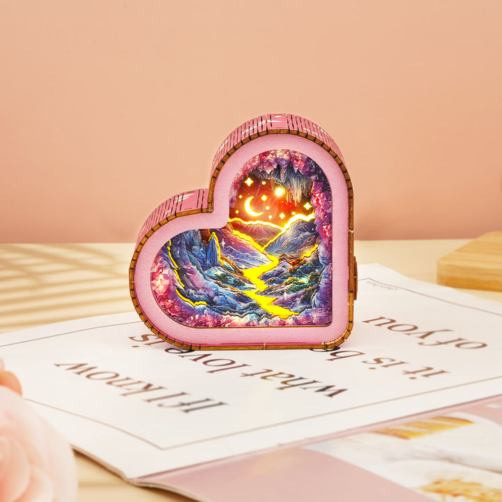 Dreamy Mine Cave Kit heart-shaped wooden puzzle night light illuminating a scenic landscape with mountains and rivers.