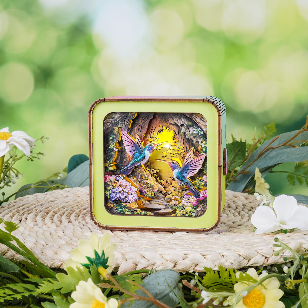 Colorful 3D wooden puzzle night light featuring hummingbirds in a vibrant floral setting.
