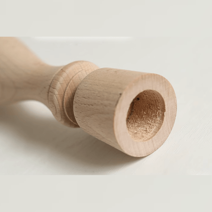 Close-up of a Nordic vintage wooden candle holder made from natural beech wood, showcasing its simple retro design.