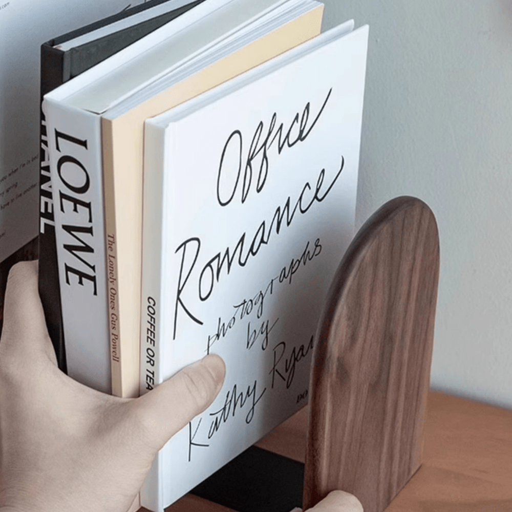 Stylish wooden bookends supporting books, showcasing walnut and beech textures in a modern home setting.