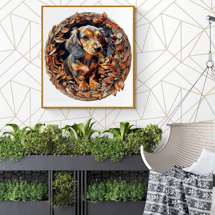 Framed artwork of a Dachshund surrounded by autumn leaves, displayed in a modern living space with greenery.