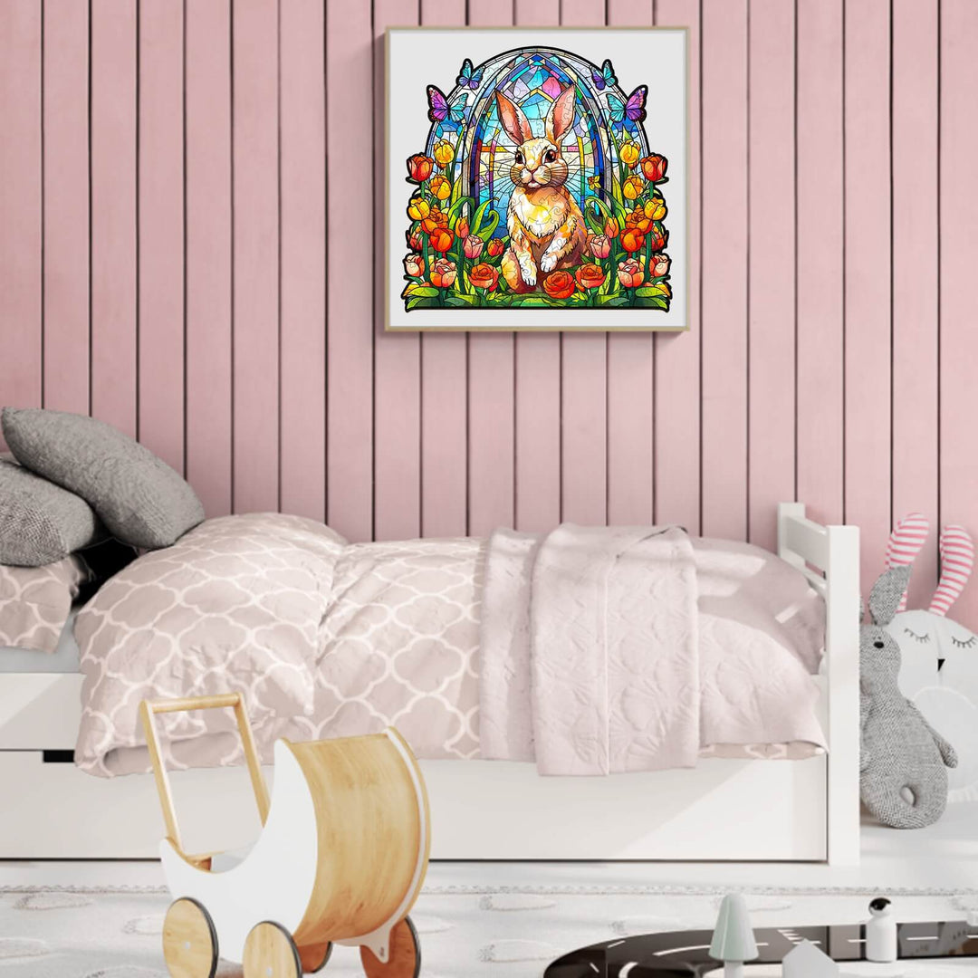 Stained glass rabbit artwork in a kids' bedroom with a pink wall, bed, and playful decor.
