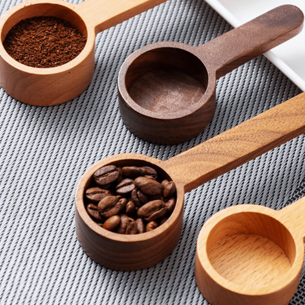 Set of wooden measuring spoons for precise cooking, featuring beech and walnut varieties, ideal for recipes or coffee.