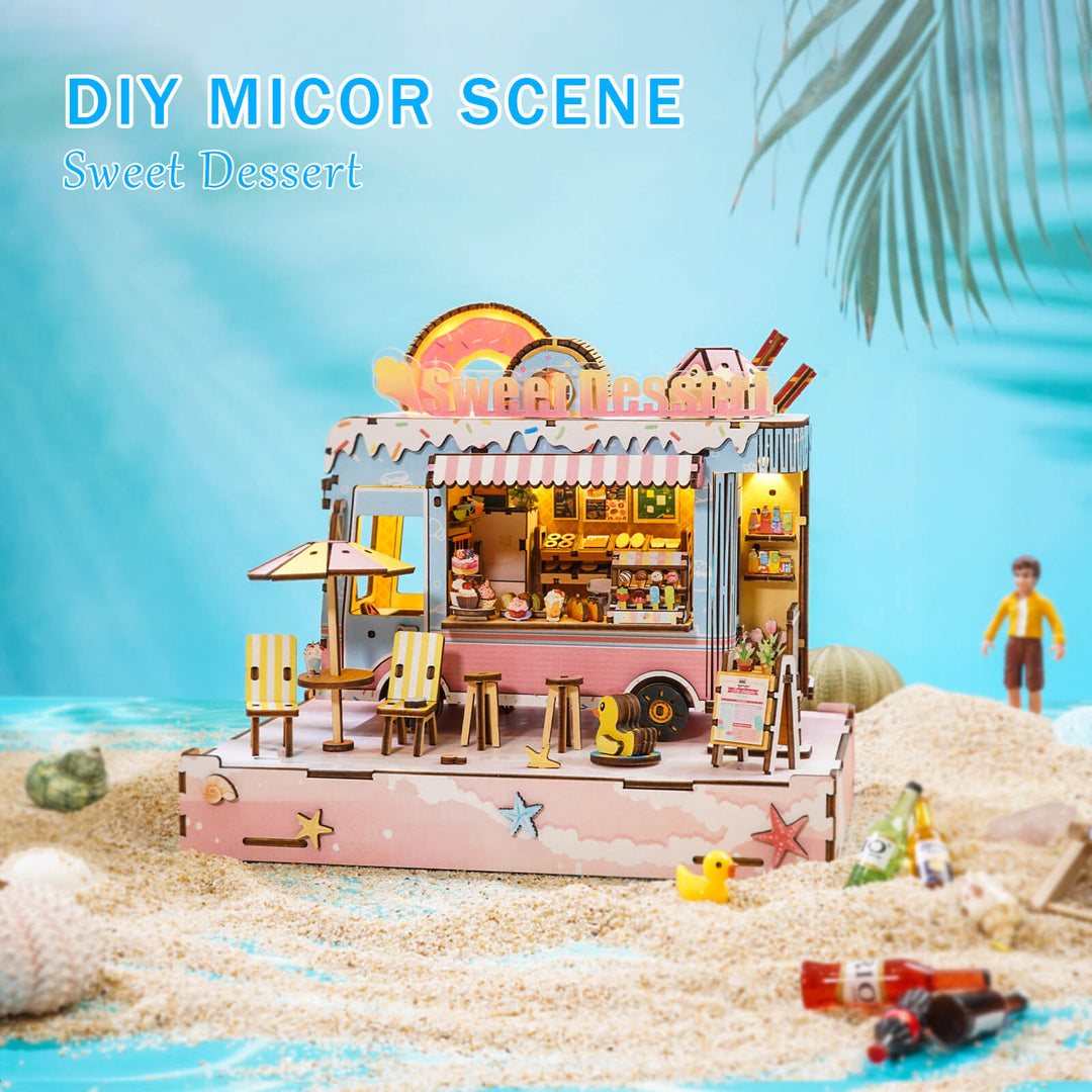 DIY miniature dessert cart scene with detailed wooden design on a sandy beach.
