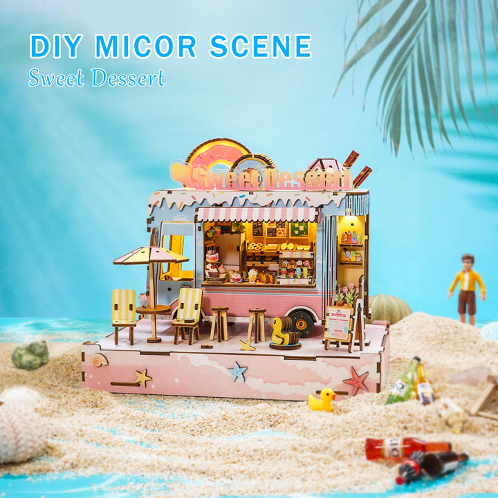 DIY miniature dessert cart scene with detailed wooden design on a sandy beach.