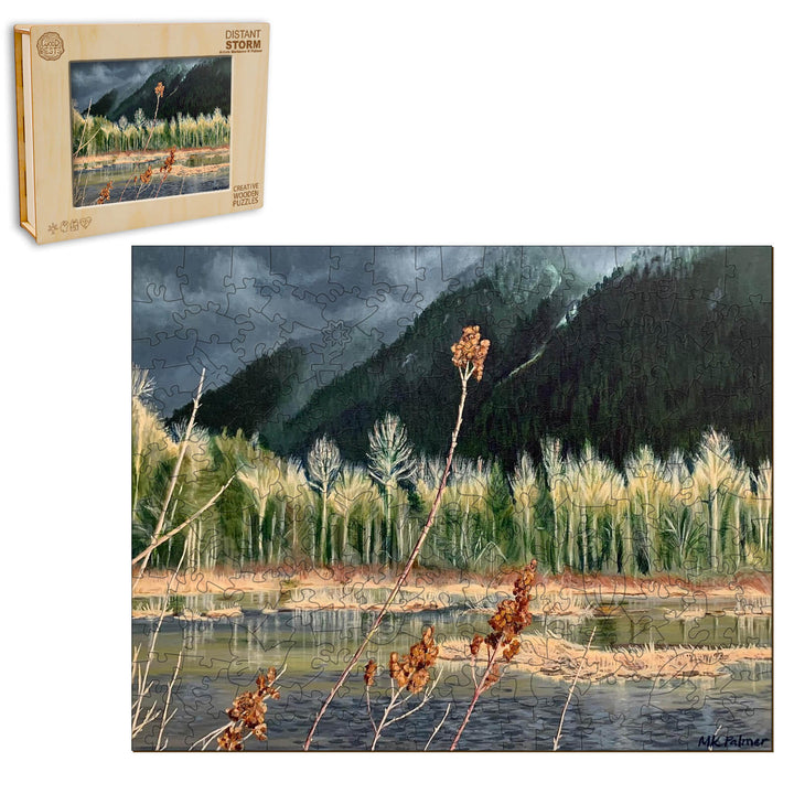 Distant Storm puzzle featuring artwork by Marianne K Palmer, showcasing a dramatic landscape with mountains and a serene water body.