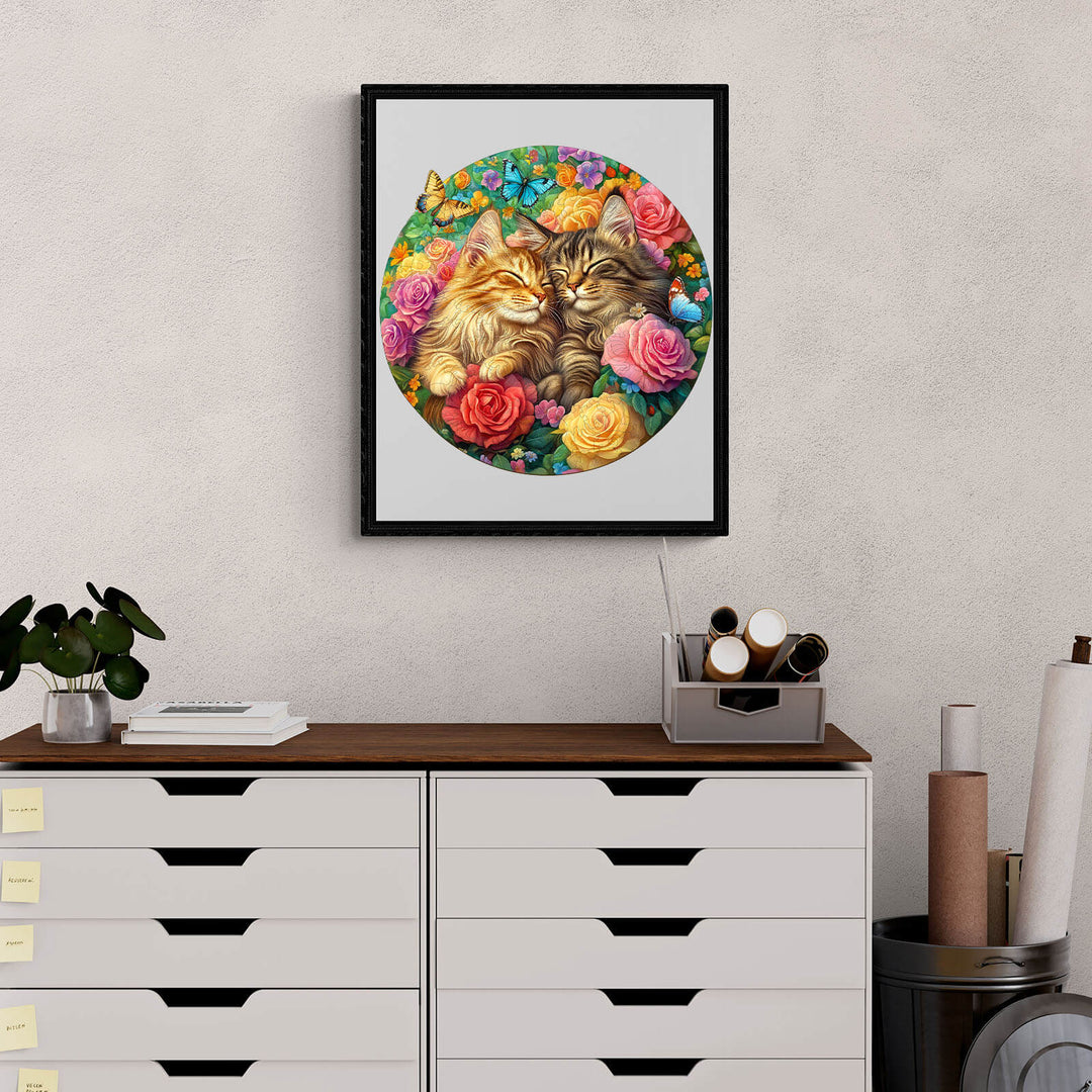 Framed artwork of two cats surrounded by flowers on a modern wooden desk, enhancing home decor.
