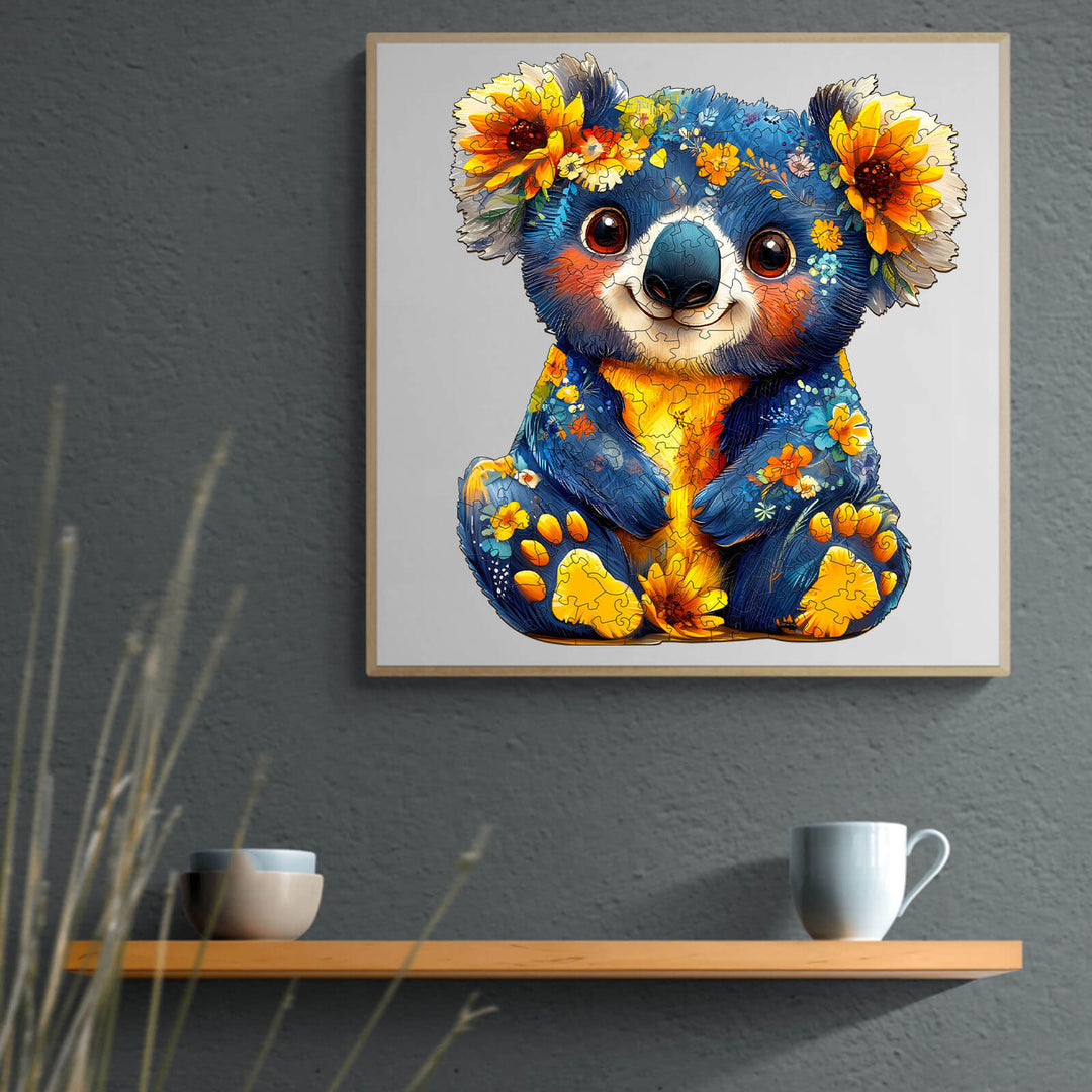 Colorful koala artwork with flowers, featured on a shelf with two cups, adding charm to any room decor.