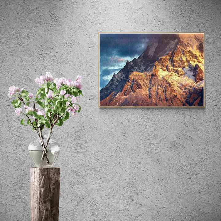 A beautiful jigsaw puzzle display of a snowy mountain at sunrise, enhancing interior decor with vibrant nature.