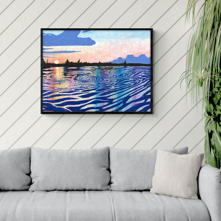 Framed artwork titled 'Black Rapids View' by Sarah Bradfield, showcasing colorful water reflections on canvas.