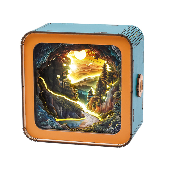 3D wooden puzzle night light featuring a sunset wilderness landscape with mountains, trees, and a river.