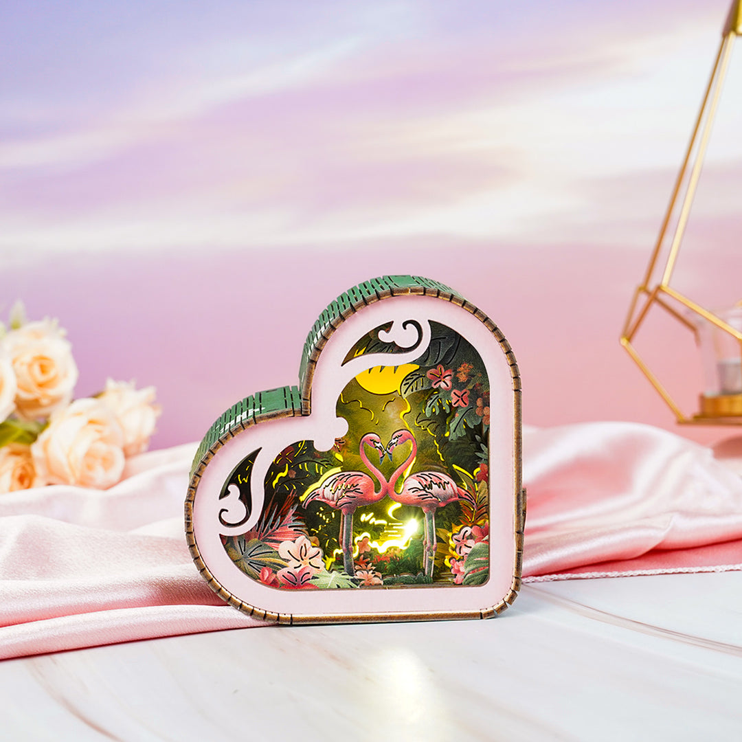 Flamingo with moonlight forest design 3D wooden puzzle night light, heart-shaped and vibrant, set against soft pastel background.