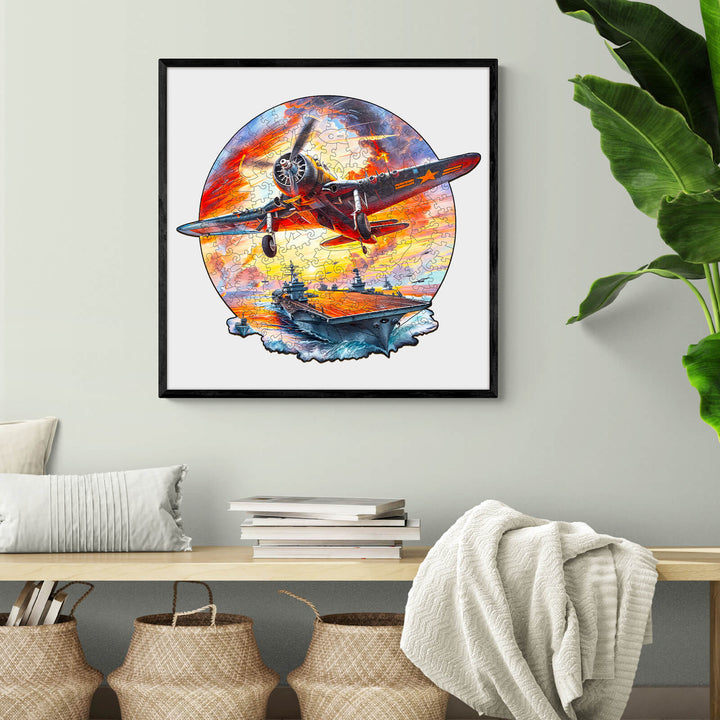 Colorful illustration of a fighter plane soaring over an aircraft carrier, framed and displayed in a cozy living room.