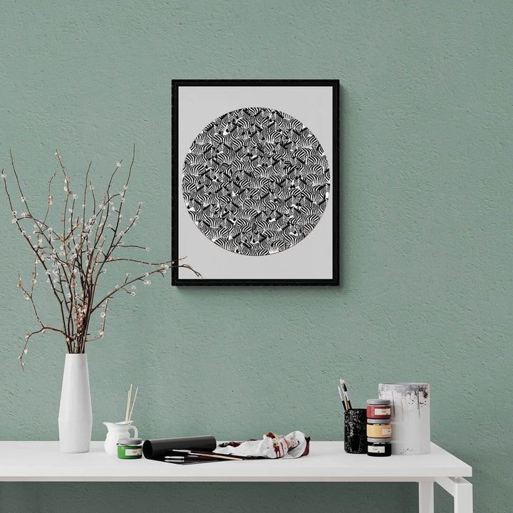 Black and white abstract wall art print in a modern interior setting with decor items.
