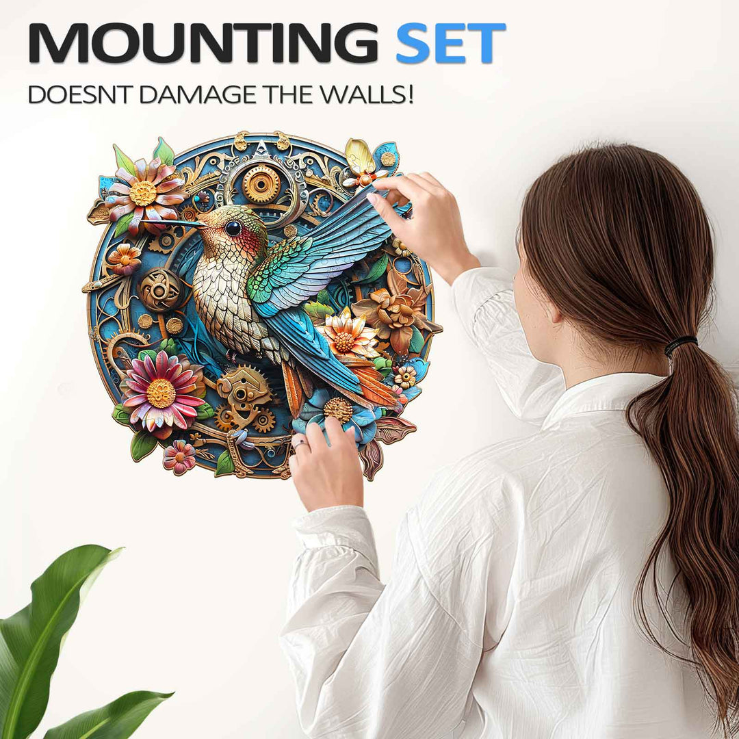 Woman mounting a colorful hummingbird wooden jigsaw puzzle on a wall without damage, showcasing the puzzle design.