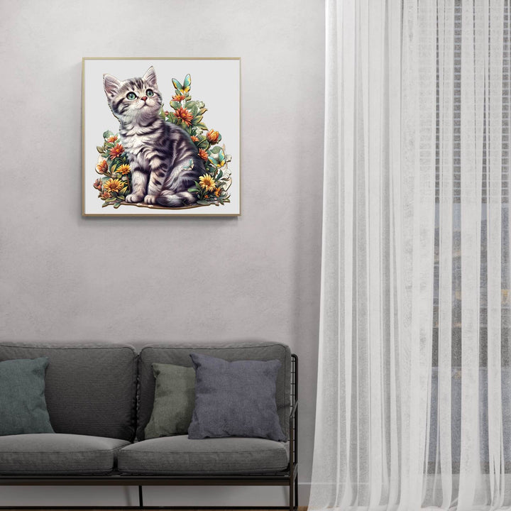 Decorative artwork of an American Shorthair kitten among flowers, enhancing home ambiance in a cozy living room.