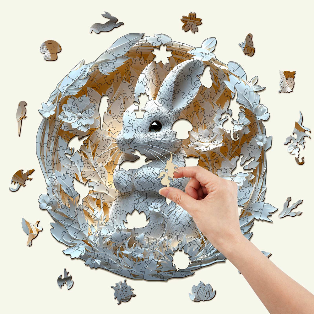 3D Paper Rabbit wooden jigsaw puzzle with a hand placing a piece, showcasing intricate design and focus-enhancing fun.