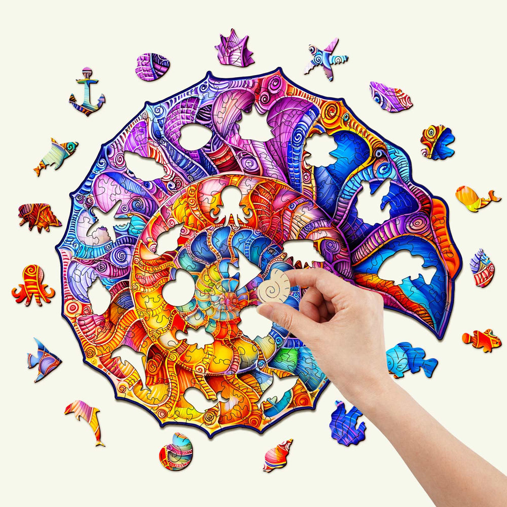 A hand assembling a colorful Nautilus wooden jigsaw puzzle, featuring vibrant marine-themed pieces and intricate designs.