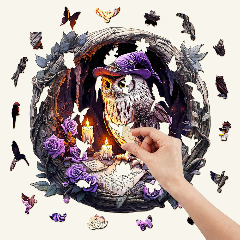 Hand placing a piece in the 3D Witch Owl wooden jigsaw puzzle, featuring a whimsical owl in a magical setting.