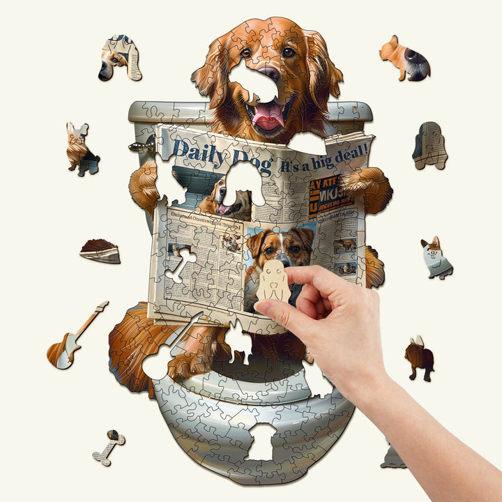 Hand assembling a Leisure Time wooden jigsaw puzzle featuring a golden retriever reading the Daily Dog magazine.
