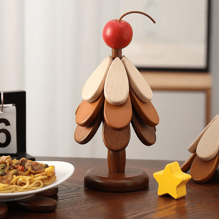 Wooden Christmas tree decoration with multi-colored leaves and a red cherry on top, adding a festive touch to dining.