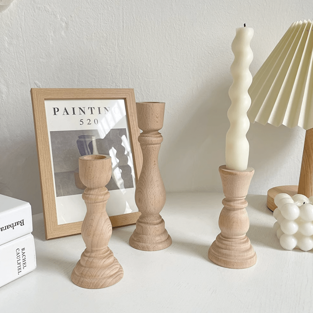 Nordic vintage wooden candle holders in a decorative setting with candles and art, enhancing a warm atmosphere.