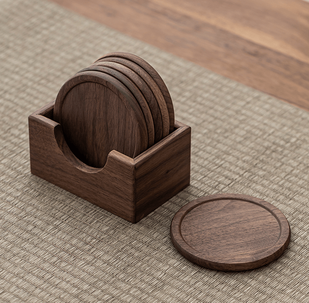Minimalist walnut coasters in a wooden holder, showcasing natural texture and elegant design for tabletops.