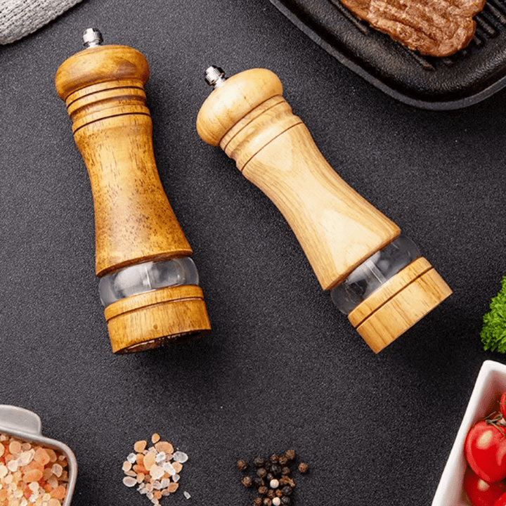 Two-tone rubberwood spice grinder set on a kitchen countertop, showcasing its natural finish and sleek design.