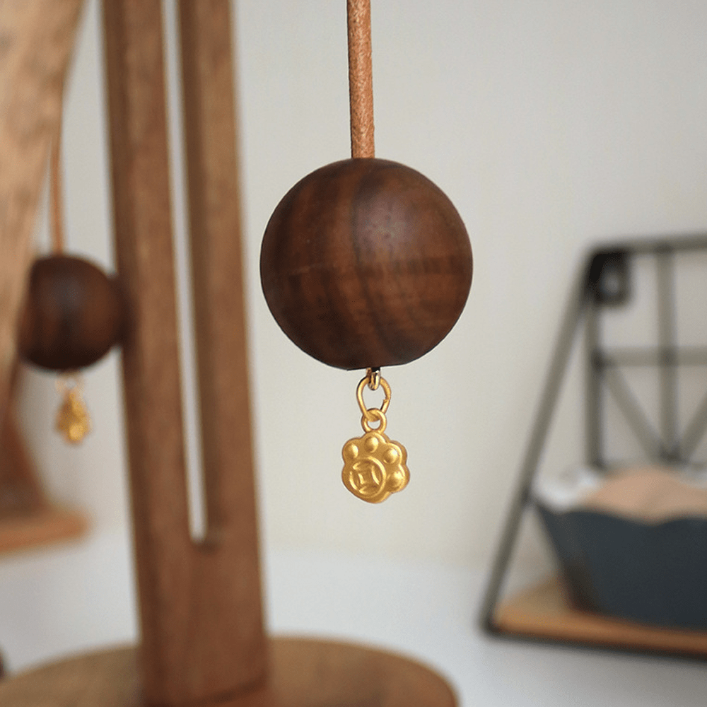 Close-up of wooden ball with pendant for a stylish kitchen paper towel holder.
