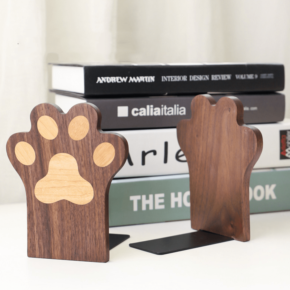 Cat paw bookend in walnut wood, cute design supporting books on a shelf, adding charm and stability.