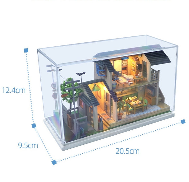 Japanese-style DIY dollhouse kit displayed in a clear case, featuring intricate wooden design and miniature furniture.