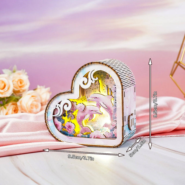 Heart-shaped 3D wooden puzzle night light featuring dolphins and fantasy ocean scenery with vibrant colors.