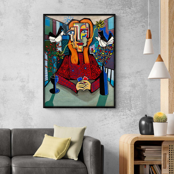 Colorful abstract artwork 'Enigmatic Nature' by Dylan Gill, featuring a figure with floral elements, displayed in a modern living room.