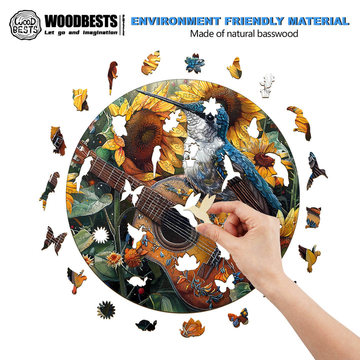 Person assembling an elegant hummingbird wooden jigsaw puzzle on a nature-themed design with sunflowers and butterflies.
