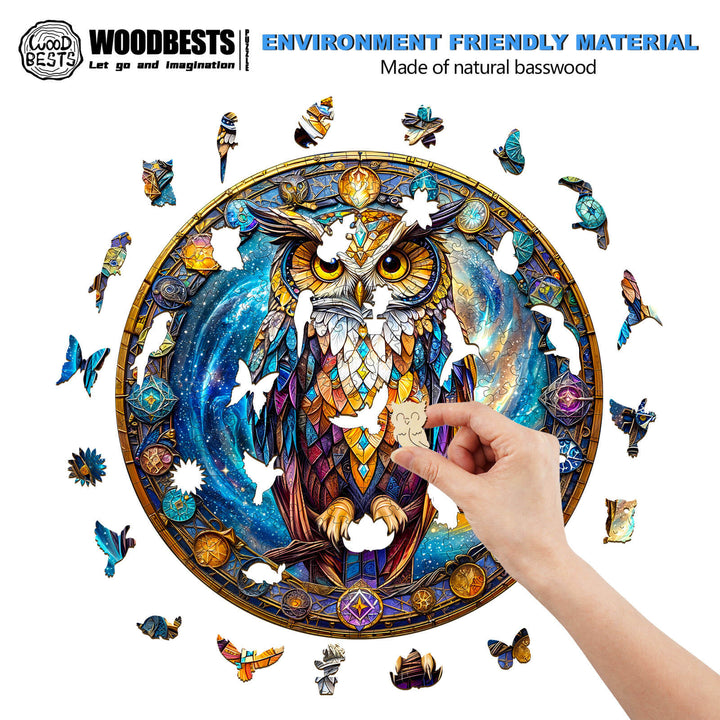 Person assembling the Cosmic Watcher wooden jigsaw puzzle featuring an owl design with colorful butterflies.