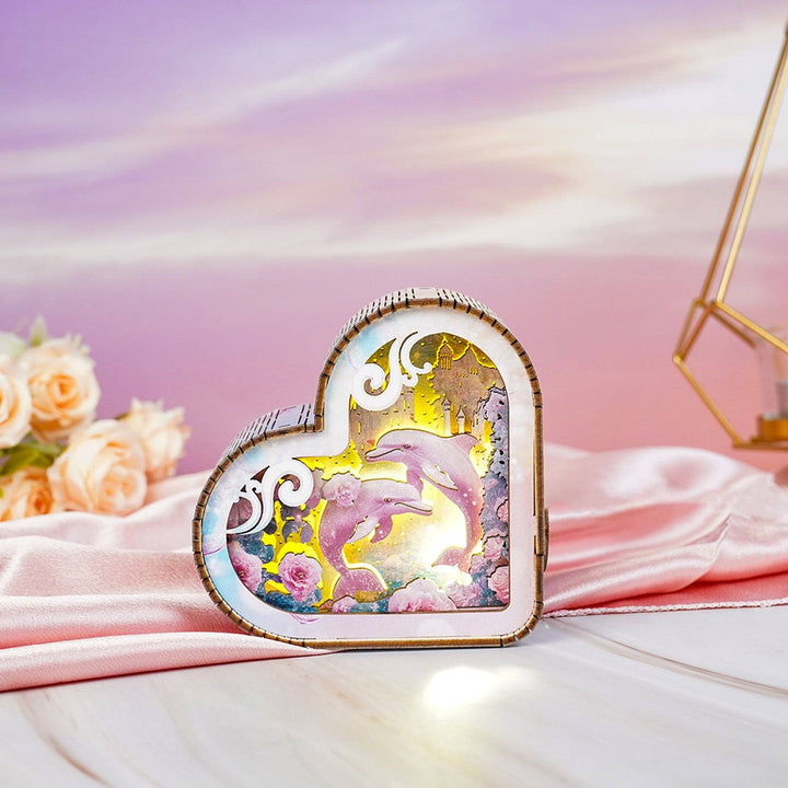 Heart-shaped 3D wooden puzzle night light featuring dolphins and colorful ocean-themed design.