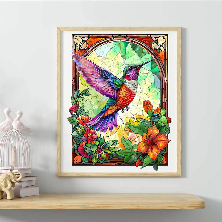 Colorful stained glass hummingbird artwork framed with vibrant flowers and greenery, perfect for home decor.