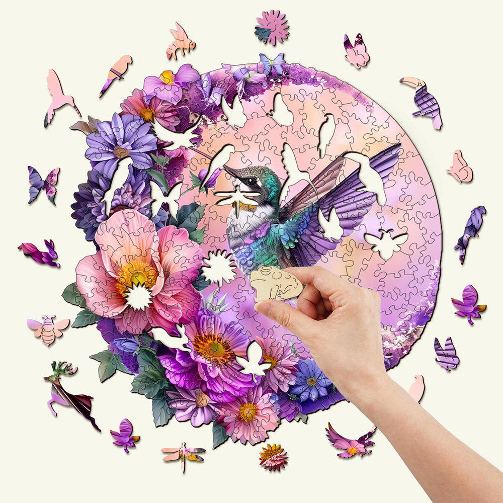 Hummingbird and Moon wooden jigsaw puzzle being assembled with colorful floral pieces.