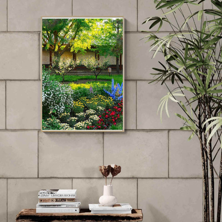 Colorful garden scenery puzzle art displayed on a wall, showcasing vibrant flowers and lush greenery.