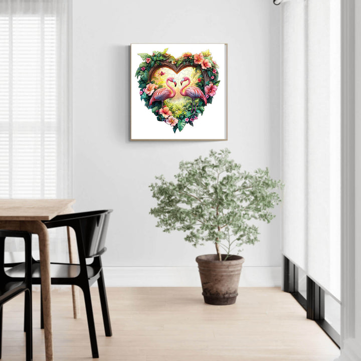 Heart-shaped artwork of flamingos surrounded by flowers in a modern home setting.