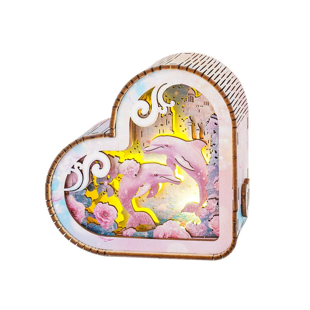 3D wooden puzzle night light shaped like a heart featuring dolphins and ocean scenery in vibrant colors.