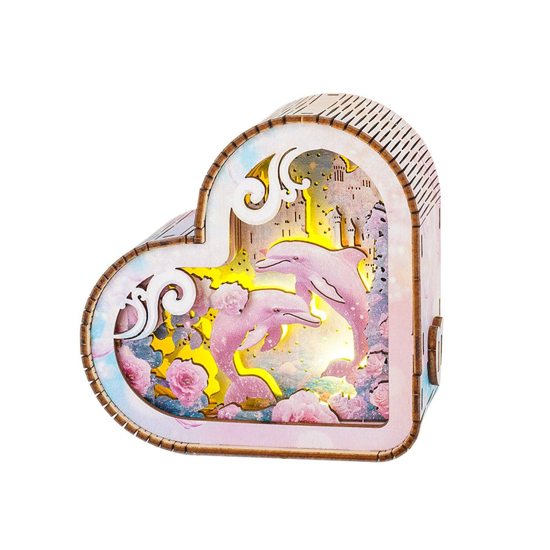 3D wooden puzzle night light shaped like a heart featuring dolphins and ocean scenery in vibrant colors.