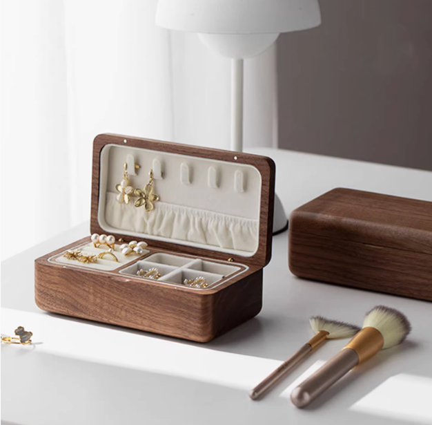 Elegant wooden double-layer jewelry box showcasing earrings and rings, perfect for organizing jewelry decoratively.