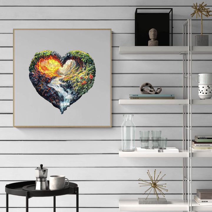 Heart-shaped artwork depicting a vibrant landscape with fire and water elements, showcased on a modern shelf.