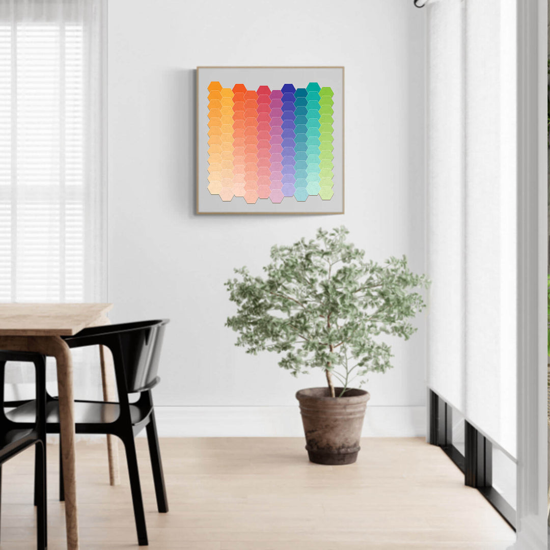 Rainbow gradient art puzzle hanging in a bright room with a plant, showcasing colorful jigsaw puzzle pieces.