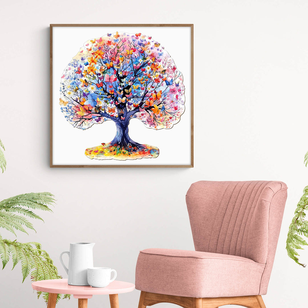 Colorful Life Tree artwork displayed in a modern living room with pink chair and plants.