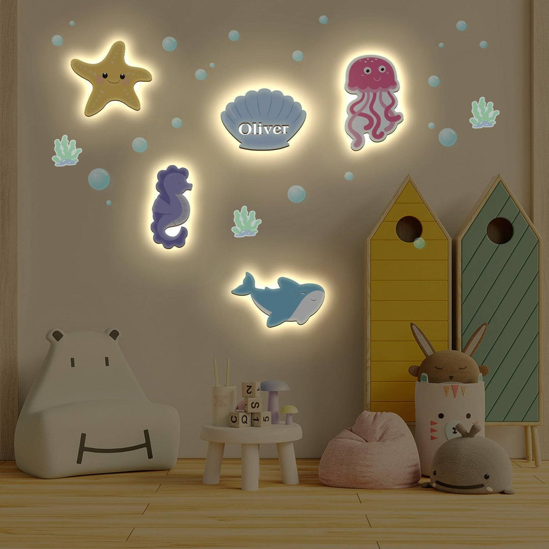 Marine-themed personalized wooden wall light set for a child's bedroom, featuring colorful sea creatures.
