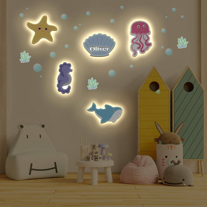 Marine-themed personalized wooden wall light set for a child's bedroom, featuring colorful sea creatures.