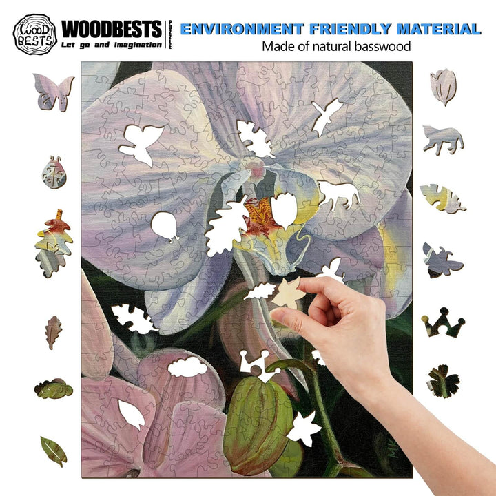 Hand assembling a wooden puzzle of an orchid artwork, showcasing eco-friendly design and creativity.